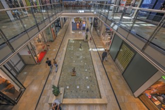 Shops and fountain with frog king in Forum Allgäu, Kempten, Allgäu, Swabia, Germany