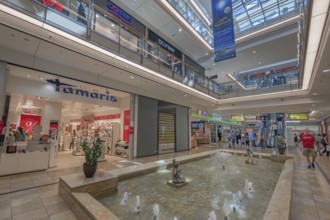 Shops and fountain with frog king in Forum Allgäu, Kempten, Allgäu, Swabia, Germany