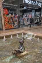 Fashion shop and fountain with frog king and coins in Forum Allgäu, Kempten, Allgäu, Swabia,