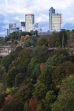 City skyscrapers rise above lush, colorful trees and natural landscape in Niagara Falls, Ontario,