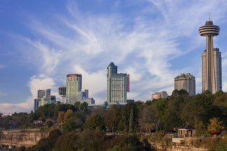 Urban skyline with modern skyscrapers set against vibrant blue skies and greenery in Niagara Falls,