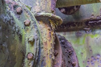 Weathered rundown industrial detail with old corroded metal tubes and fittings
