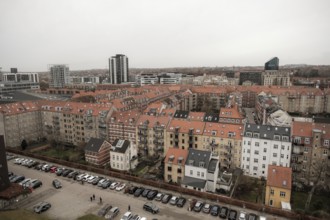 Panoramic urban view with uniform red-tiled rooftops under a gray sky in Aarhus, Denmark, Northern