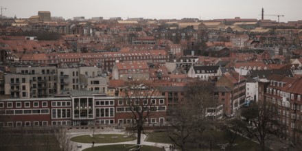 Aerial view of a city with red-tiled rooftops under an overcast sky in Aarhus, Denmark, Northern
