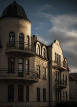 Sunlit historic European building with dramatic shadows against a cloudy sky in Helsingborg,