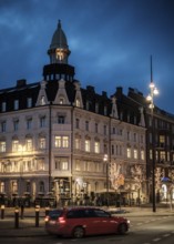 Historic building illuminated at night in a city area with streetlights in Helsingborg, Sweden,
