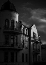 Historic European building in black and white with dramatic shadows and cloudy sky in Helsingborg,