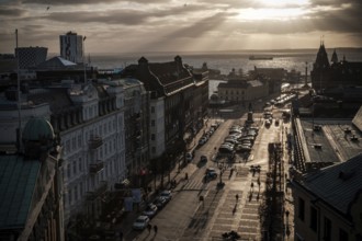A street leading to the Oresund Strait under a dramatic sunset and clouds as seen from Helsingborg,