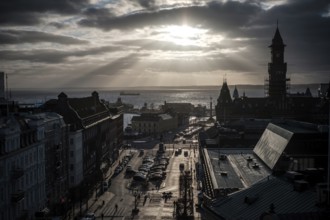 A dramatic city view with a silhouette against a sunset over the Oresund Strait, between Sweden and