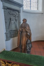 Church of St Gallus and Ulrich, figure of St Gallus with the bear next to an epitaph, Kisslegg,