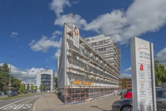 Blue sky, white clouds, scaffolded medical centre at the Forum, Kempten, Allgäu, Swabia, Germany