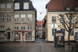 Narrow alley between historic buildings with a poster on the wall in Helsingor, Denmark, Northern