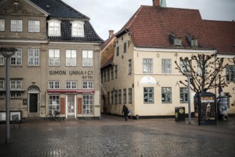 Daytime scene with historic buildings lining an empty cobblestone square in Helsingor, Denmark,