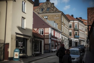 Charming street with colorful buildings and a hotel under a blue sky in Helsingborg, Sweden,
