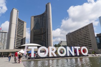 Toronto sign in front of Toronto City Hall with a bright blue sky in Toronto, Ontario, Canada,