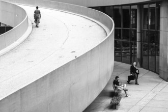 People moving along a curved ramp in a cityscape in Toronto, Ontario, Canada, North America
