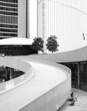 A curved ramp between modern buildings in a black and white setting in Toronto, Ontario, Canada,