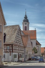 Pointed gable house with half-timbering and St Gallus and Ulrich church, Kisslegg, Allgäu,