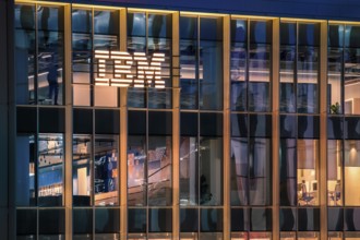 Jan 15, 2025 - Lisbon, Portugal: Nighttime view of IBM office building with glowing logo and sleek