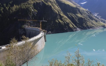 Waterfall bottom reservoir, dam wall, construction site, mountain panorama, energy industry, hiking