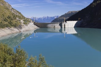 Waterfall bottom reservoir, dam wall, construction site, mountain panorama, energy industry, hiking
