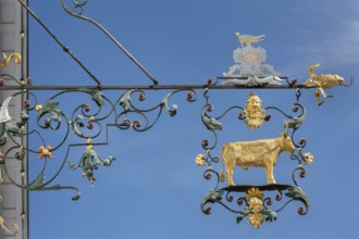 Wrought iron nose plate with golden bull in Kisslegg, Allgäu, Baden-Württemberg, Germany