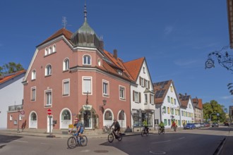 Blue sky, street with cyclists, pointed gable houses and ZAPPA BAR in Kisslegg, Allgäu,