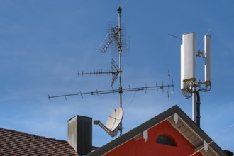 Red pointed gable with antennas and chimney, Allgäu, Baden-Württemberg, Germany
