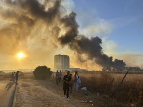 Faro, Algarve - September 21, 2025: People watching a big fire in the suburbs of Faro, capital city