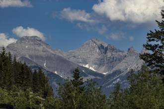Rocky mountain peaks under a blue sky with clouds inside Yoho National Park in British Columbia,