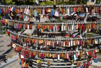 Close-up of numerous colourful padlocks attached to metal rings, Nuremberg, Middle Franconia,