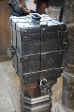 An antique metal box with a lock on a wooden floor, rustic and historic in appearance, St. Lawrence
