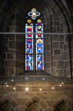 Stained glass window with artistic depictions in a Gothic church, Church of St. Lawrence,