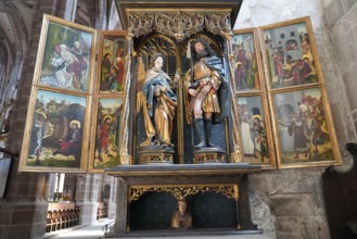 Historic altar with sculptures and religious paintings in a church, Church of St. Lawrence,