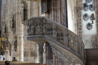 Detail of an ornately carved pulpit in an old church with depictions and figures, Church of St