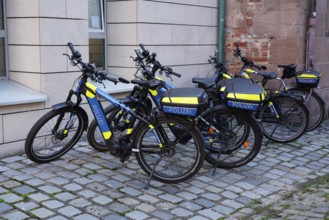 Police bikes with neon-coloured elements parked on cobblestones, Nuremberg, Middle Franconia,