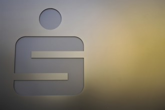 Metallic symbol half in the light on a gold-coloured background, Nuremberg, Middle Franconia,