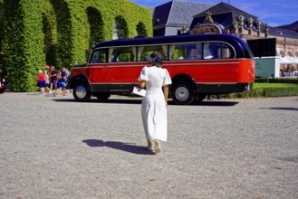 MERCEDES-BENZ 3500, built in 1950, retro bus in a park setting with a woman in the foreground,