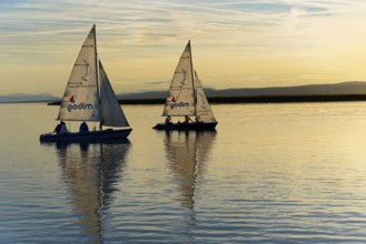 Lake Neusiedl, Burgenland, Austria, Europe, Two sailboats at sunset with soft light over calm water