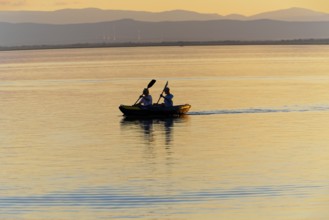 Lake Neusiedl, Burgenland, Austria, Europe, Two people in a canoe, setting in the peaceful dusk,