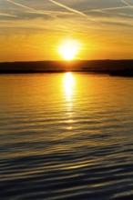 Lake Neusiedl, Burgenland, Austria, Europe, A magnificent sunset is reflected in the calm waters,