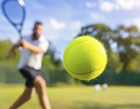 AI generated image showing a flying tennis ball closeup and player in court ambiance