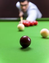AI generated image showing a billiards table closeup with player and balls