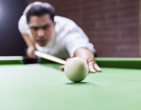 AI generated image showing a billiards table closeup with player and cue ball