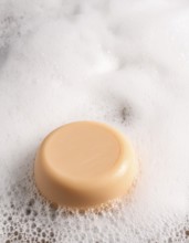 AI generated closeup image showing a soap bar and foam