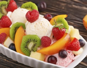 Closeup shot of a ice cream sundae with fresh fruits on wooden ground, AI generated image