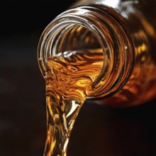 AI-generated close-up image showing a bottle as a clear drink is poured from it, AI generated