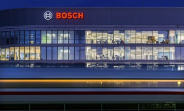Modern office building of Bosch GmbH in Feuerbach at night with illuminated logo of the automotive