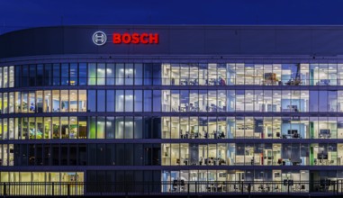 Modern office building of Bosch GmbH in Feuerbach at night with illuminated logo of the automotive