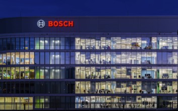 Modern office building of Bosch GmbH in Feuerbach at night with illuminated logo of the automotive